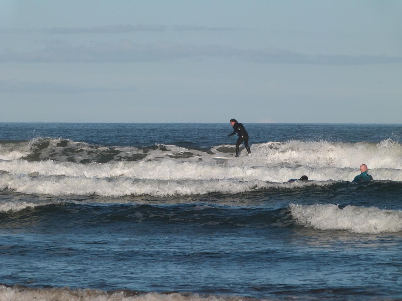 Club members surfing on a local trip